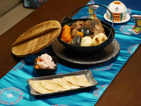 Khorkhog — hot-stone lamb in a cast-iron pot with pickles and flatbread